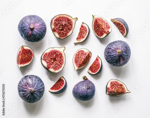 Fresh figs. Food Photo. Creative scheme of the whole and sliced figs on a white background, inscribed in a rectangle. View from above. Copy space