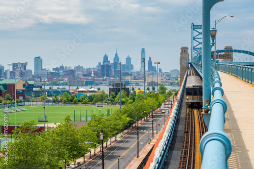 Skyline of Philadelphia, Pennsylvania, USA as seen from Camden New Jersey, featuring the Delaware River and Benjamin Franklin Bridge