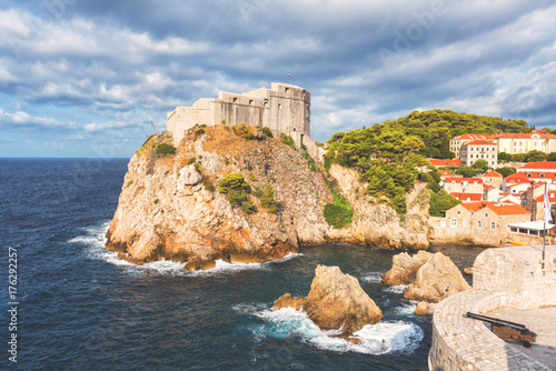 Dubrovnik medieval fortress Lovrijenac (St. Lawrence) on the rock, beautiful landscape with blue cloudy sky and Adriatic sea, popular view from the ancient city wall, Croatia
