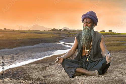 Sadhu meditation near river