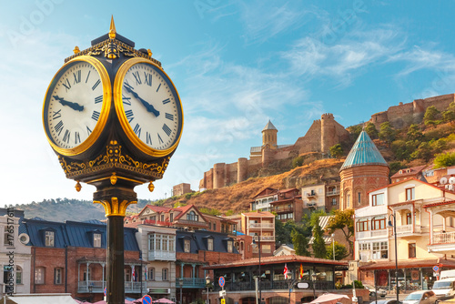 Amazing view of City clock, Old Meidan Square and Narikala ancient fortress in the sunny morning, Tbilisi, Georgia.