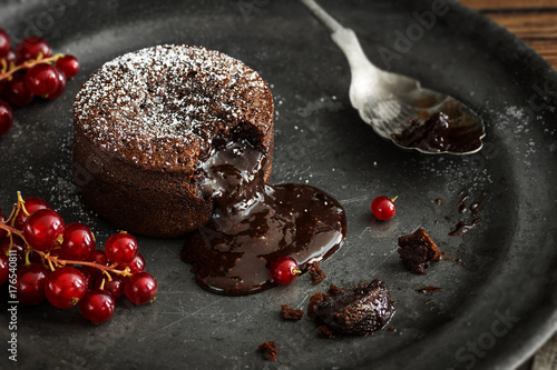 Chocolate Lava Cake with Gooey Molten Center Pouring on to Plate