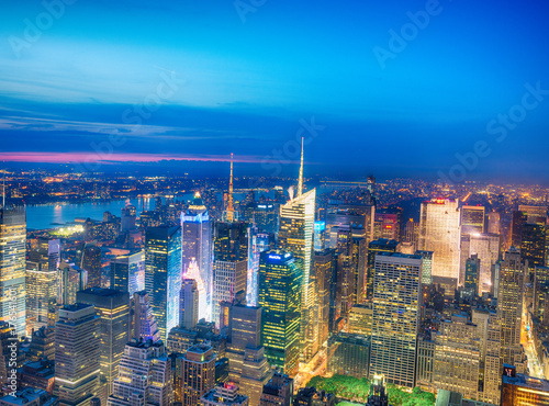 NEW YORK CITY - JUNE 9, 2013: Night aerial view of Midtown skyscrapers. New York attracts 50 million tourists every year