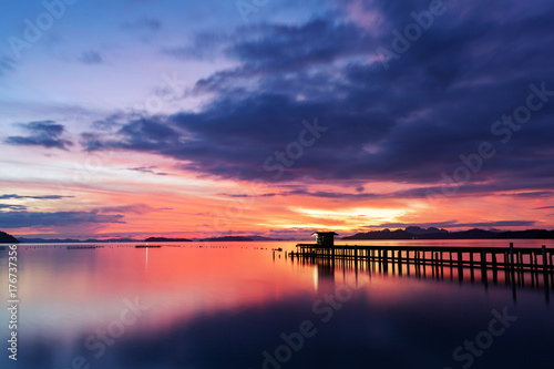 scenery view of old jetty to the sea beautiful sunrise or sunset dramatic sky in phuket thailand.