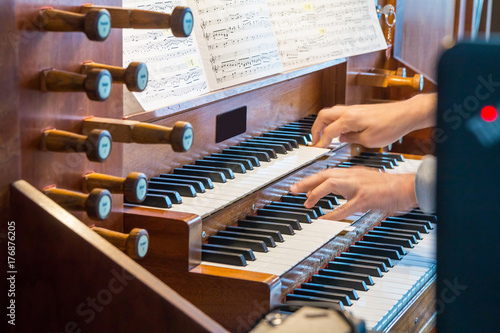 Close up view of a organist playing a pipe organ