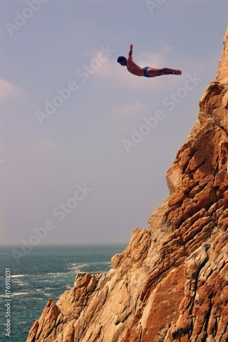 Acapulco coast. Divers diving from the rock. Mexico.