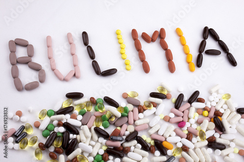 Conceptual Hand writing text caption inspiration Medical care Health concept written with pills drugs capsule word bulimia On white isolated background with copy space