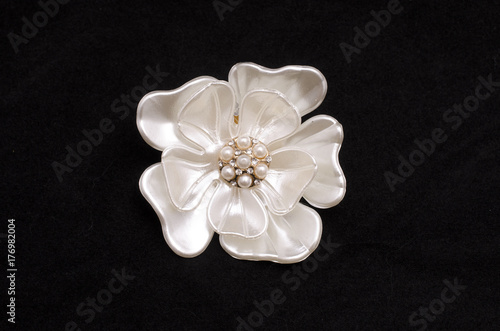 Brooch flower with pearls isolated on black