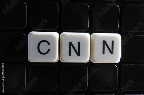 Cnn text word crossword. Alphabet letter blocks game texture background.