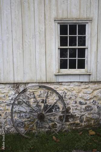 old stone and wood building with wagon wheel at Hopewell Furnace in Pennsylvania