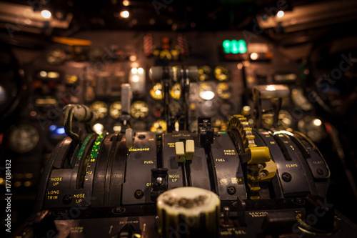 Control levers in airplane cockpit closeup with selective focus.