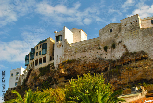 City buildings on natural stone wall.