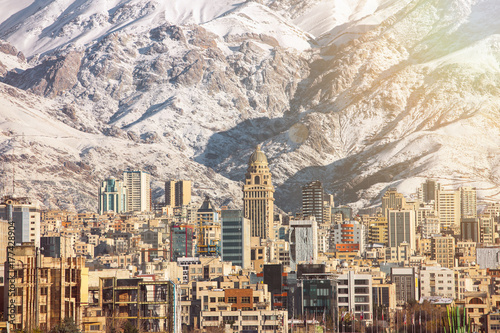 Winter Tehran view with a snow covered Alborz Mountains on background. With lens flare and light leak