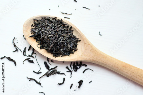 black tea in wooden spoon