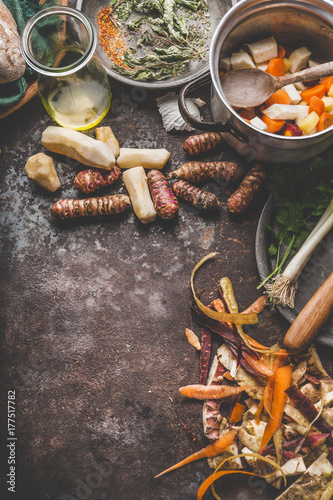 Cooking preparation of organic colorful farm root vegetables : Jerusalem artichoke, carrot, celery,parsnip on rustic kitchen table background, top view, place for text. Healthy food and eating concept