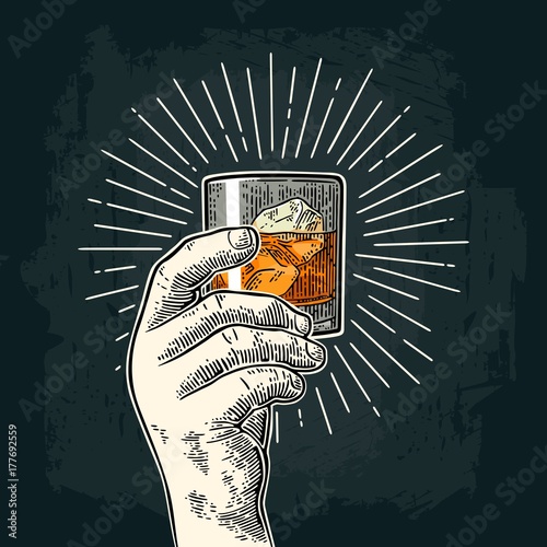 Male hand holding glass whiskey with ray