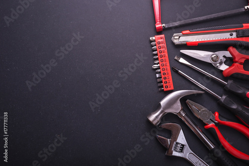 New square black tool box on black granite board background. Composition with free space for text or design