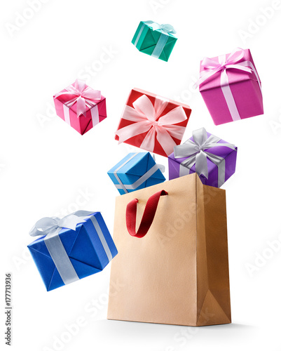 Gift boxes pop out from paper bag isolated on white background