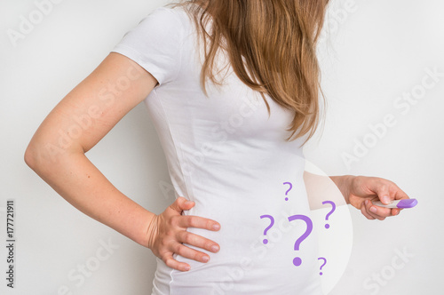 Woman with imagination of a pregnant belly - infertility concept