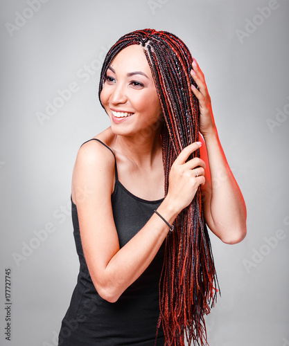Women Hairstyle with colorful hair extensions braided in thin plaits and afrobraids