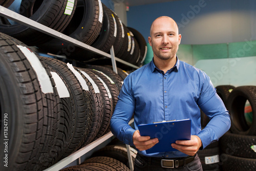 auto business owner and wheel tires at car service