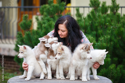 Breeder of dogs with his pets in a courtyard