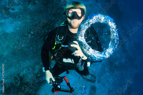 SCUBA diver blowing underwater bubble rings