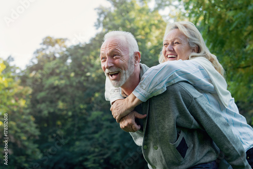 Happy senior couple smiling outdoors in nature 