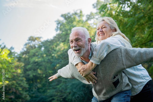 Happy senior couple smiling outdoors in nature 