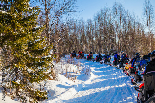 The tourist group on snowmobiles