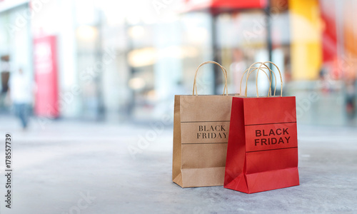 Black Friday sale shopping bags on floor front the mall store background, business, retail, banner and sign concept