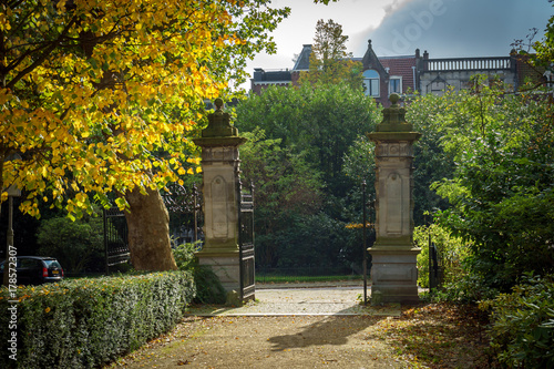 old Entrance to the park with an iron gate and a fence