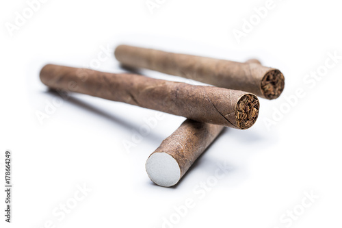 Macro Of Two Cigarillos On Top Of A Single Cigarillo Isolated On White Background