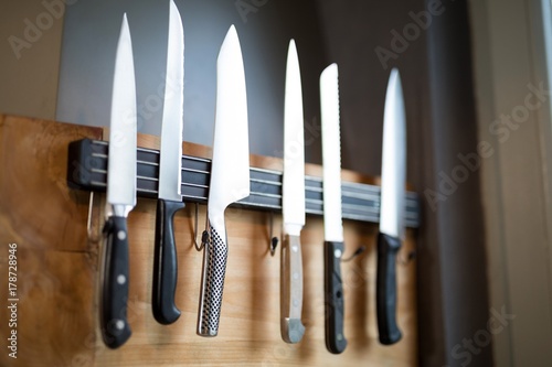 Set of kitchen knives hanging on the wall