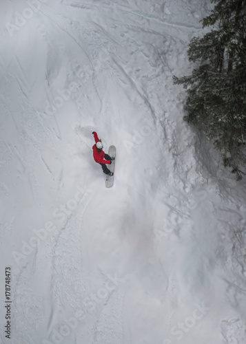 Lone snowboarder sliding down mountain