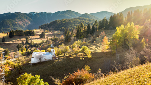 Autumn landscape with church located in village Gela, in the hearth of Rodopi Mountain, Bulgaria. Panoramic view with flairs