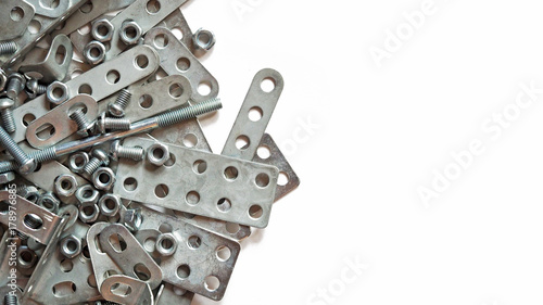 Details of silvery metal children's designer isolated on white background. Bolts, screws and nuts for assembly