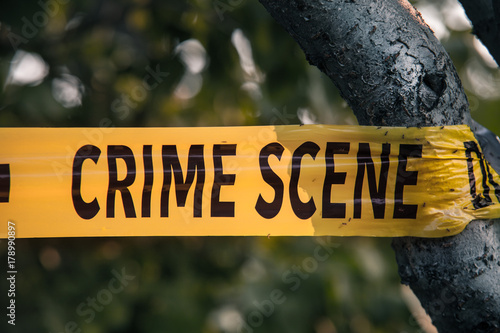 Crime scene tape closeup, police tape Do Not Cross outdoors