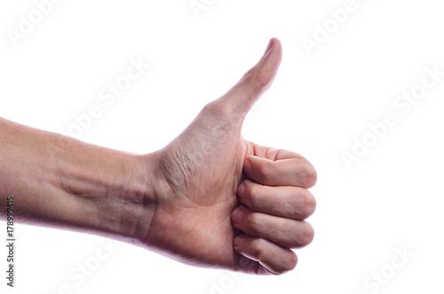 The man's hand shows a gesture of approval. Thumbs up. The hand shows gesture class. Everything is cool, you're done, praise, everything is OK, wonderful mood.