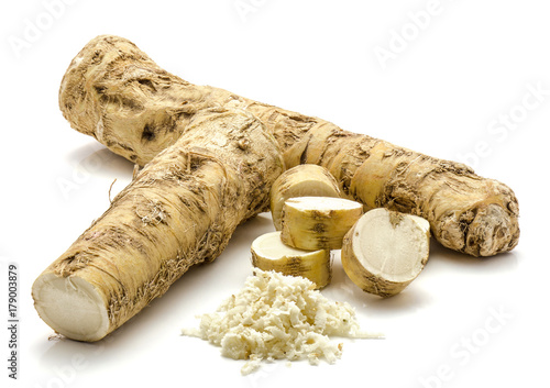 One whole, one half and freshly grated mash of horseradish root, isolated on white background, sliced circles