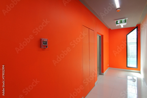 Emergency exit of the building with fire exit sign and fire alarm