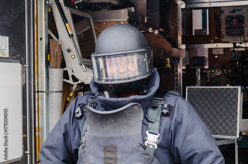 Man wearing bomb-proof suit and helmet as used by bomb squad ATOs.