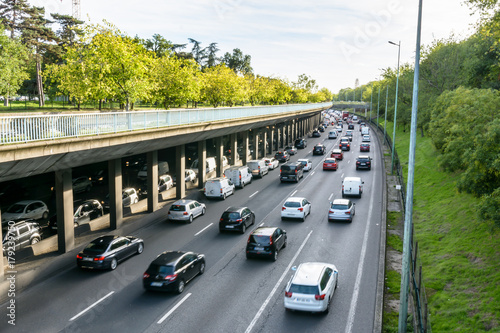 Daily heavy traffic on the half-covered western part of the eight lanes ring road of Paris at the evening rush hour.