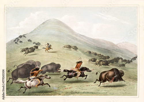 Old watercolor illustration of native indians hunting buffalos running on a vast grassland. By G. Catlin, publ. on Catlin's North American Indian Portfolio Ackerman, New York, 1845