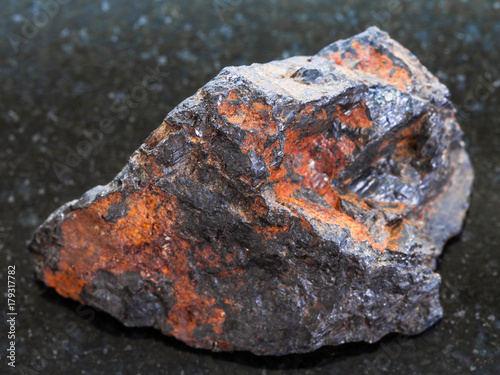 rough Wolframite stone (tungsten ore) on dark