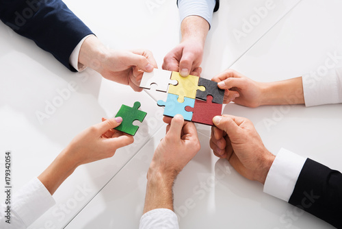 Teamwork of partners. Concept of integration and startup with puzzle pieces