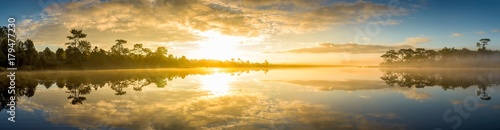 Panoramic view of sunrise over the lake in nation park, Beautiful rainforest landscape with fog in morning, Thailand