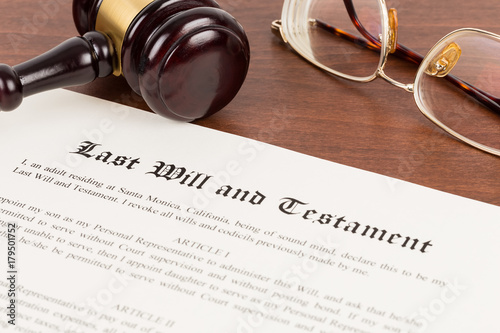 Last will and testament on yellowish paper with wooden judge gavel; document is mock-up