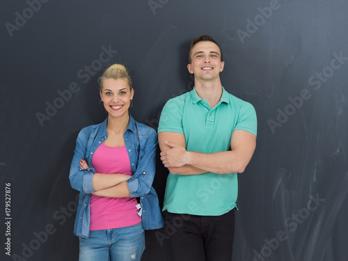 couple in front of gray chalkboard
