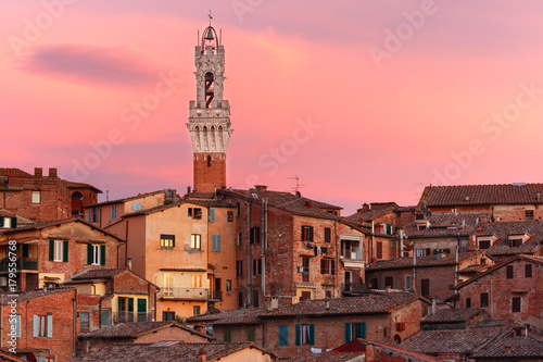 Mangia Tower or Torre del Mangia and Old Town of medieval city of Siena at gorgeous sunset, Tuscany, Italy